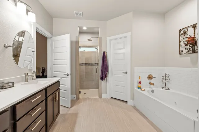 a view of a patio with a table and chairs under an umbrella
