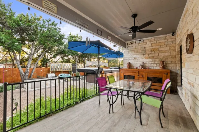 a outdoor living space with furniture and a black umbrella
