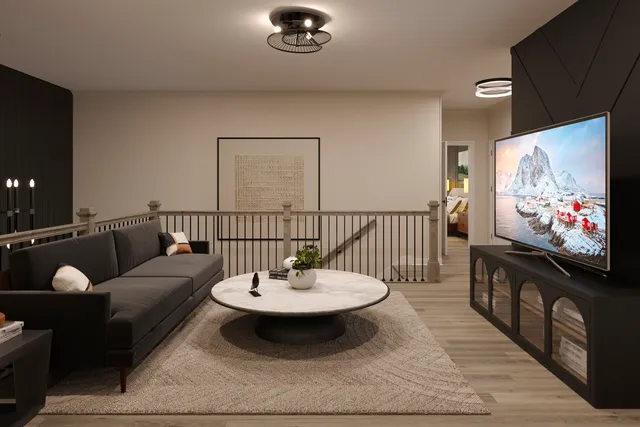 a living room with furniture a rug and a flat screen tv