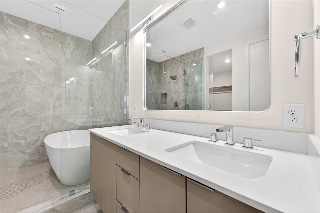 6603 Roper Street Dallas, TX 75209 - Photo 20 of 40 Primary bathroom features double sinks and spacious wet room with freestanding tub.