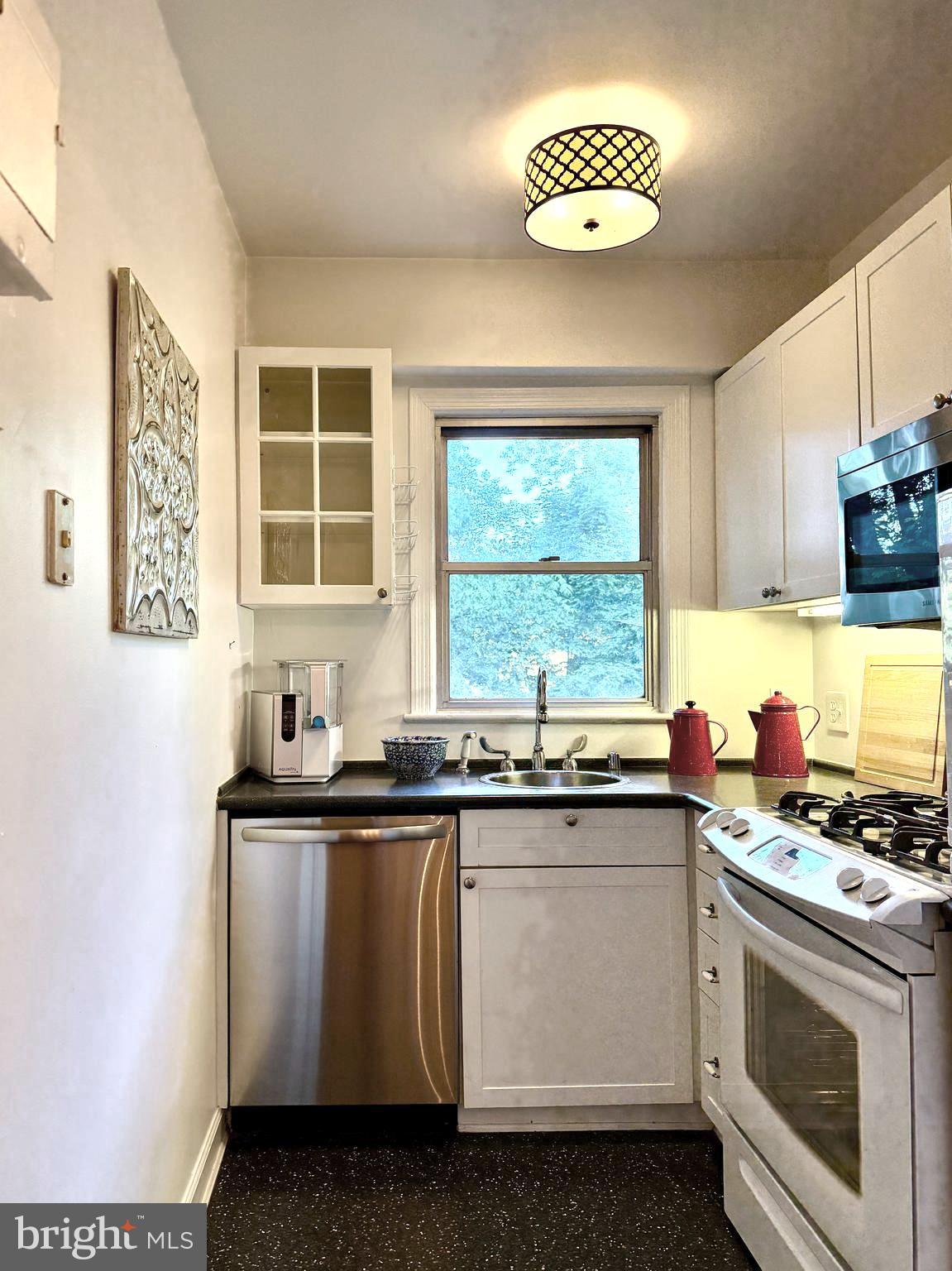 2500 Q Street Northwest, Unit 307 Washington, DC 20007 - Photo 17 of 17 a kitchen with a sink stove and cabinets