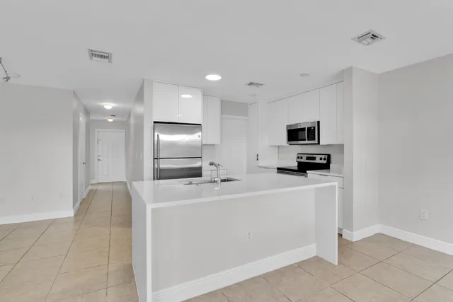 a view of kitchen with stainless steel appliances a sink dishwasher stove and refrigerator