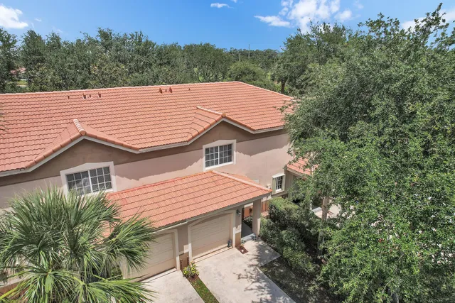 a backyard of a house with a garden and outdoor seating