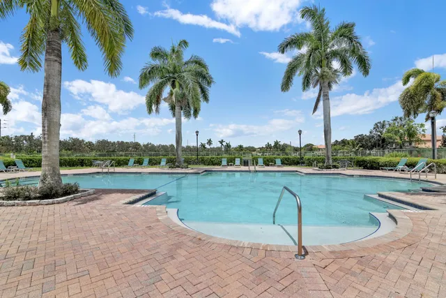 an aerial view of a house with a garden and lake view