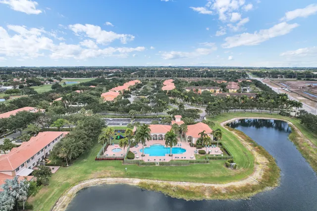 an aerial view of residential houses with outdoor space and lake view