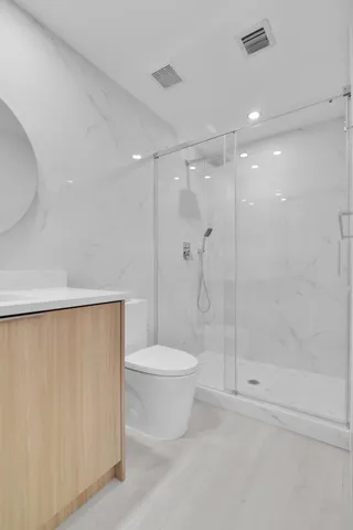 a bathroom with a shower a toilet and sink