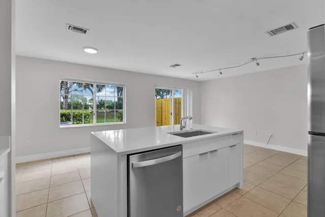 a kitchen with a sink cabinets and window