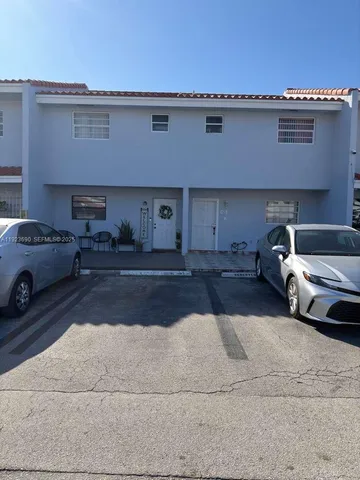 a couple of cars parked in parking area of a building