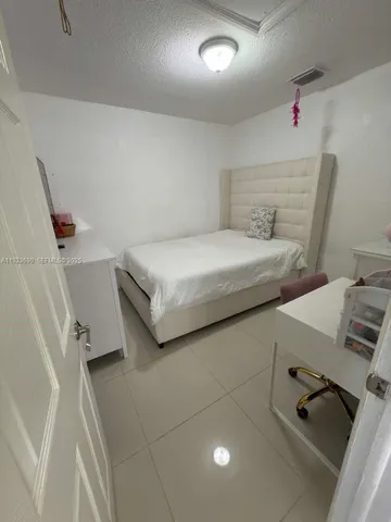 a bedroom with a bed and cabinets