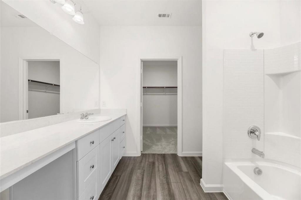 10308 Holy Cross Lane Crowley, TX 76036 - Photo 21 of 27 a bathroom with a bathtub and a sink