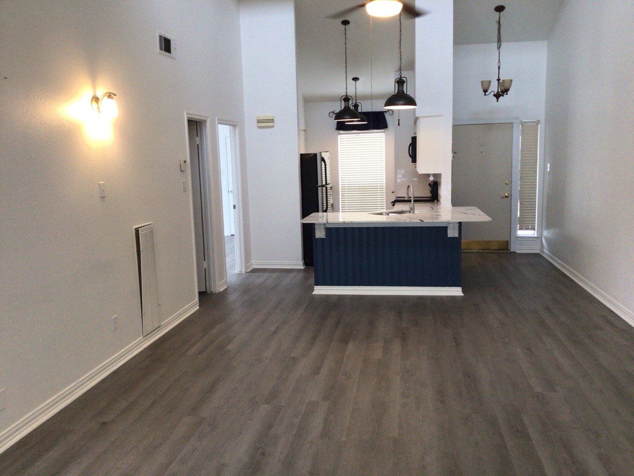 176 April Point Drive North Conroe, TX 77356 - Photo 6 of 17 a kitchen with stainless steel appliances granite countertop a refrigerator a sink dishwasher a stove and white countertops with wooden floor