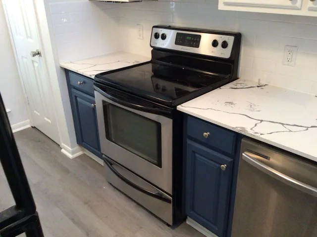 a stove top oven sitting inside of a kitchen