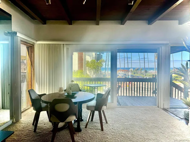a view of a dining room with furniture and window