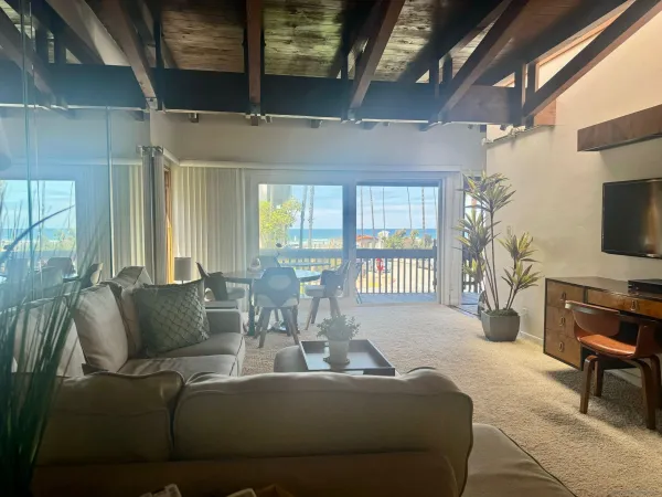 a living room with furniture a flat screen tv and a large window