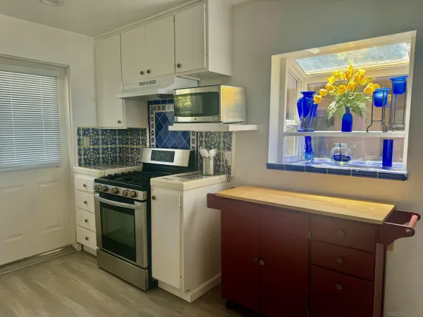 a kitchen with stainless steel appliances granite countertop a stove and a refrigerator