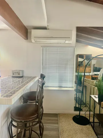 a bathroom with a granite countertop sink a mirror and shower