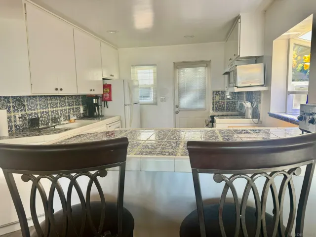a kitchen with furniture and window