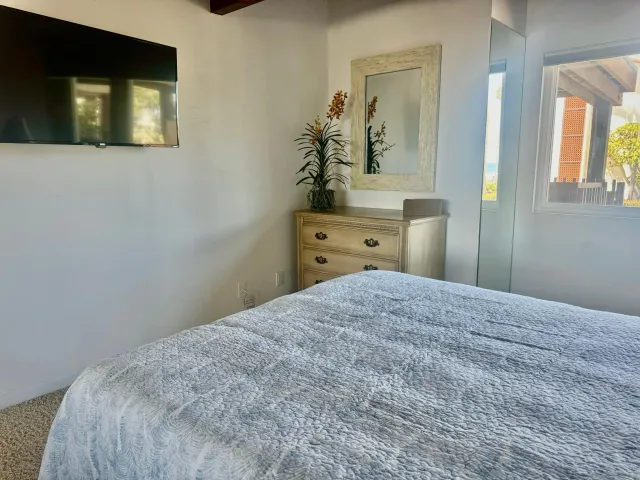 a bedroom with a bed and a mirror