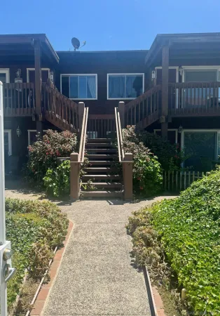 a view of a house with wooden fence