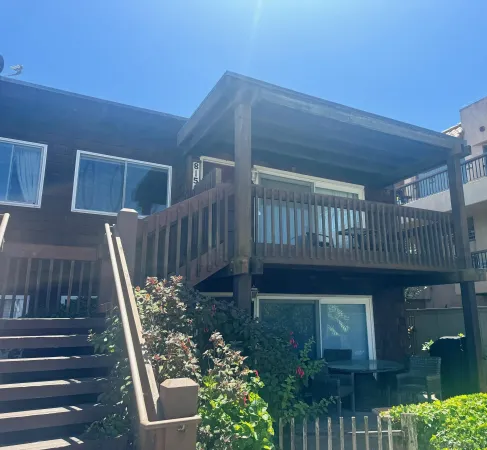 a view of a deck with wooden floor and fence