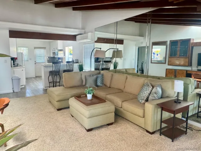 a living room with furniture and a ceiling fan