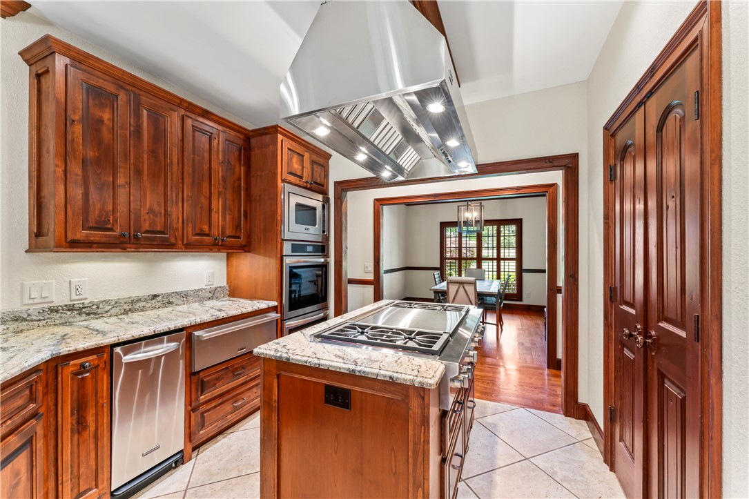 579 Terrapin Crossing Road Pickens, SC 29671 - Photo 8 of 50 A chef's dream, this kitchen features a 48 in gas cooktop island with a professional hood, 48 in built-in refrigerator, warming drawer, double ovens and built in microwave as well as a trash compactor