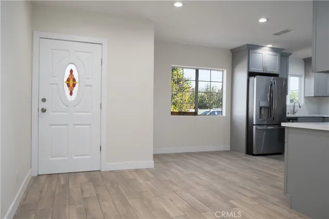 a view of kitchen with a refrigerator wooden floor and window
