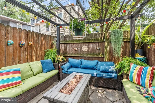 a outdoor living room with furniture and a potted plant