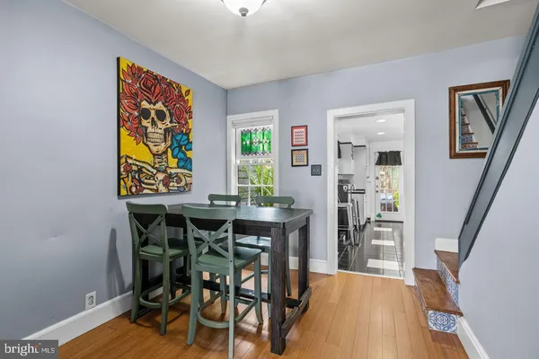 a view of a dining room with furniture and wooden floor