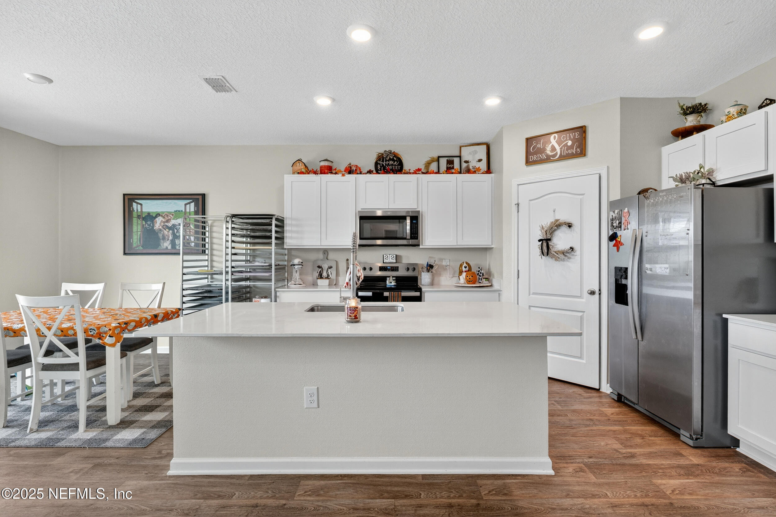 125 Hulett Wds Road Palm Coast, FL 32137 - Photo 11 of 40 a kitchen with stainless steel appliances a refrigerator and a stove top oven