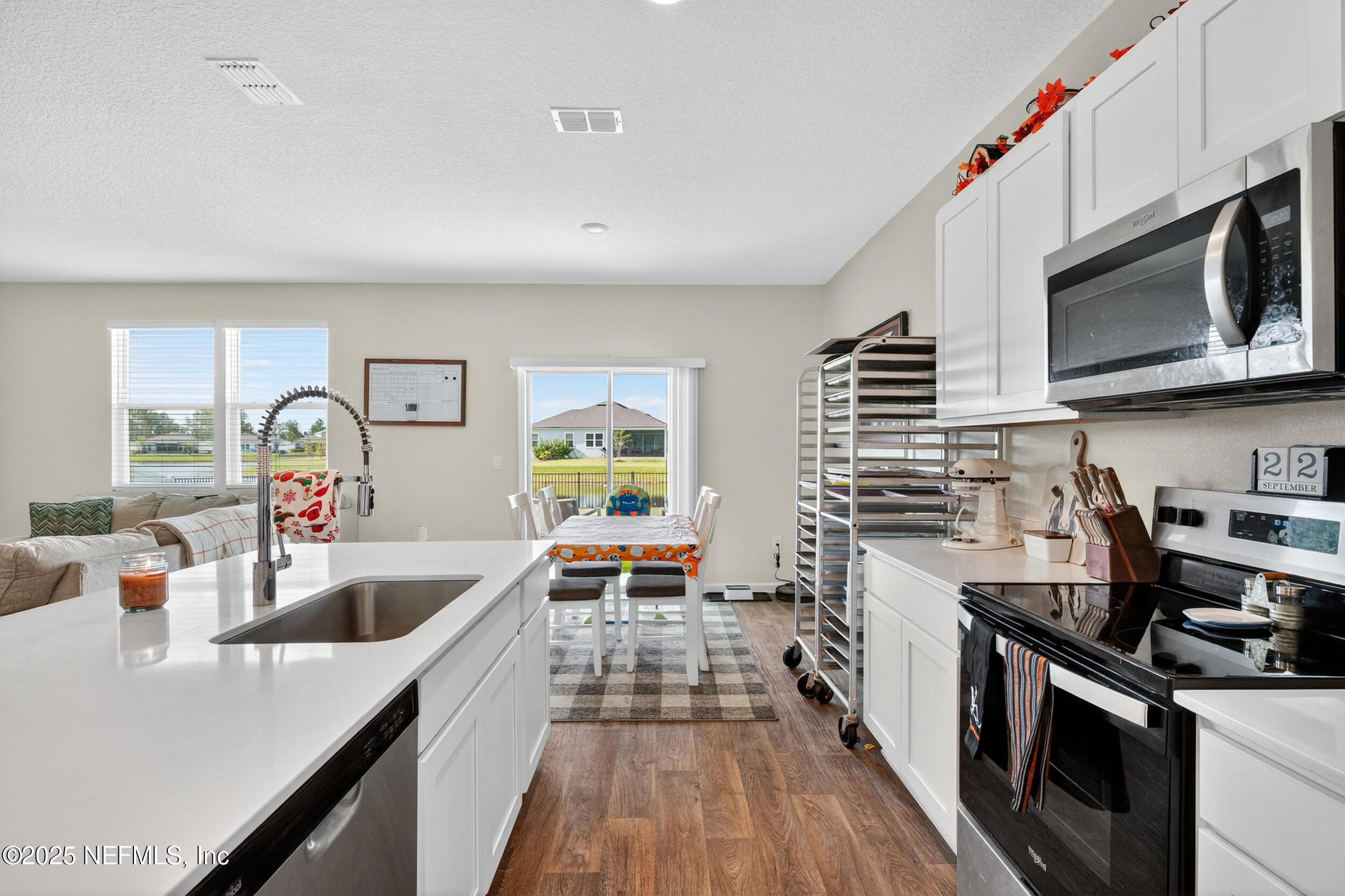 125 Hulett Wds Road Palm Coast, FL 32137 - Photo 13 of 40 a kitchen with stainless steel appliances a stove a sink and a microwave
