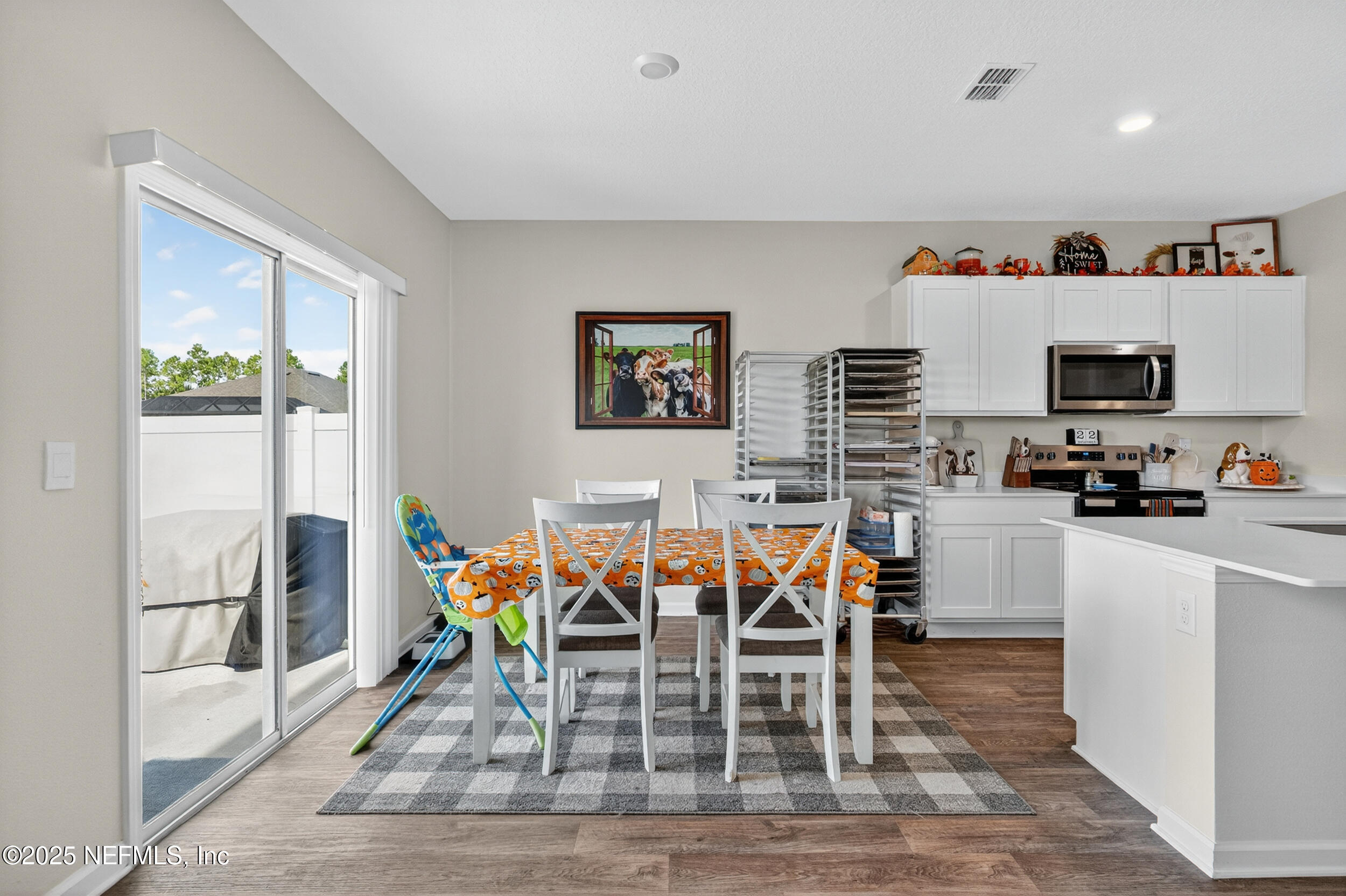 125 Hulett Wds Road Palm Coast, FL 32137 - Photo 15 of 40 a dining room filled chandelier and wooden floor