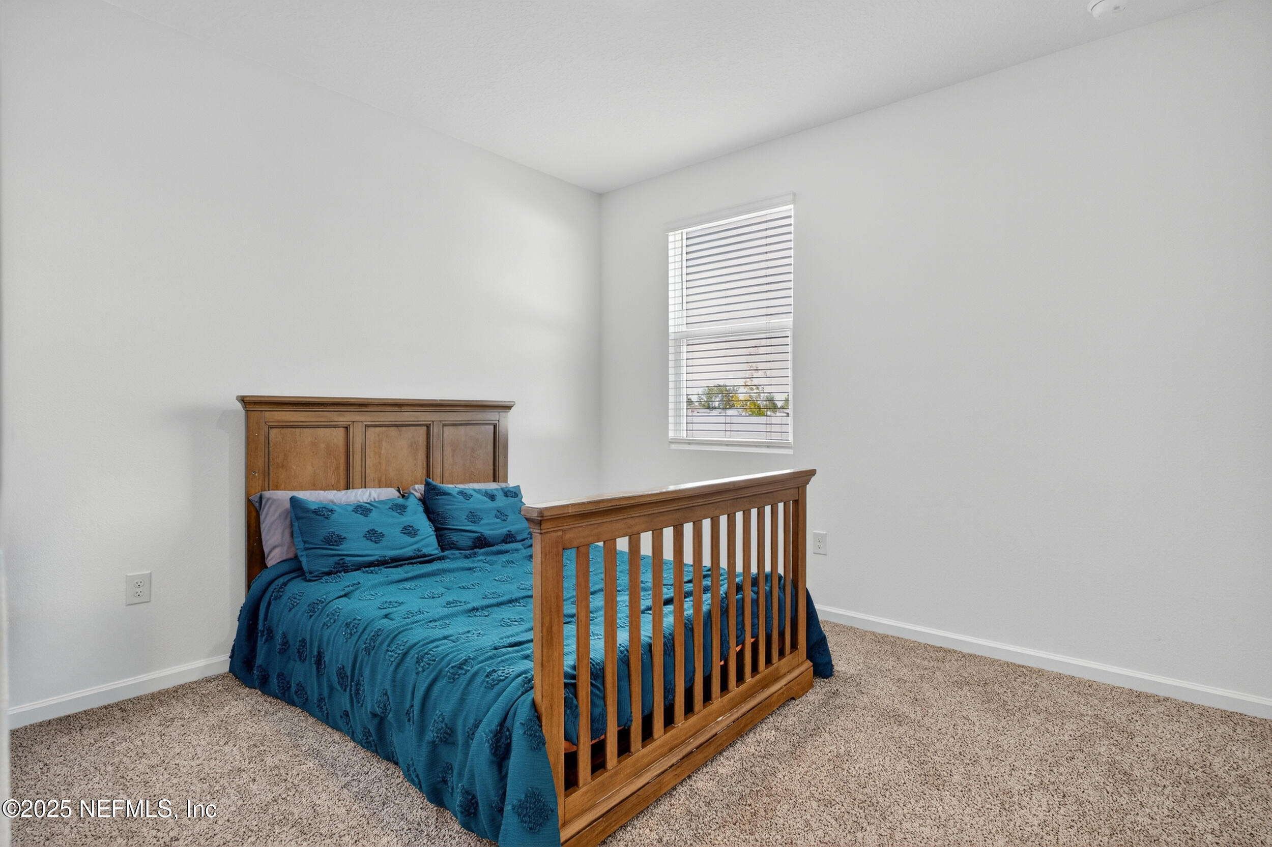 125 Hulett Wds Road Palm Coast, FL 32137 - Photo 18 of 40 a bedroom with a bed and window