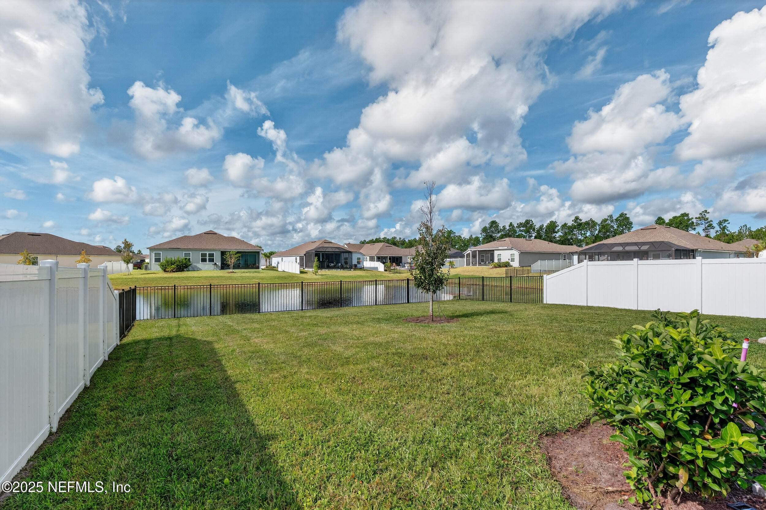 125 Hulett Wds Road Palm Coast, FL 32137 - Photo 2 of 40 a view of a big house with a big yard and large trees