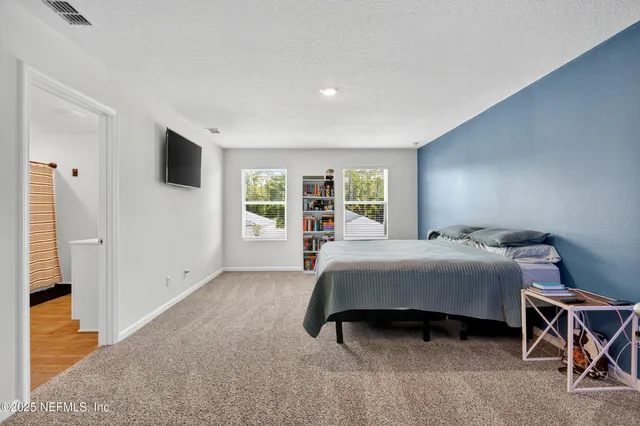 a bedroom with a large bed and a window