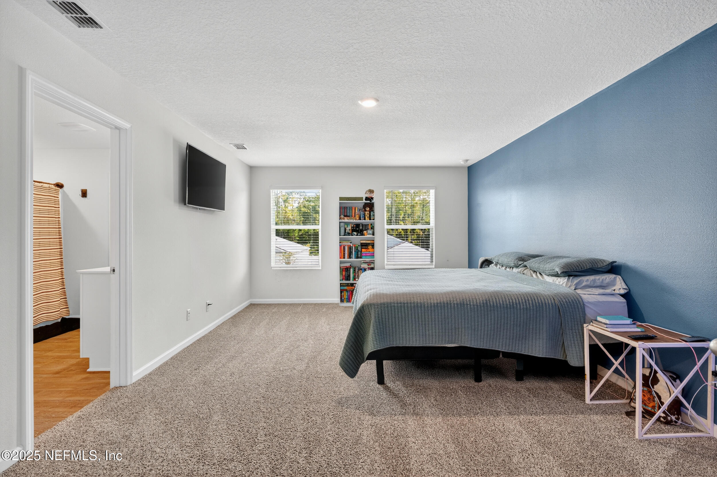 125 Hulett Wds Road Palm Coast, FL 32137 - Photo 22 of 40 a bedroom with a large bed and a window