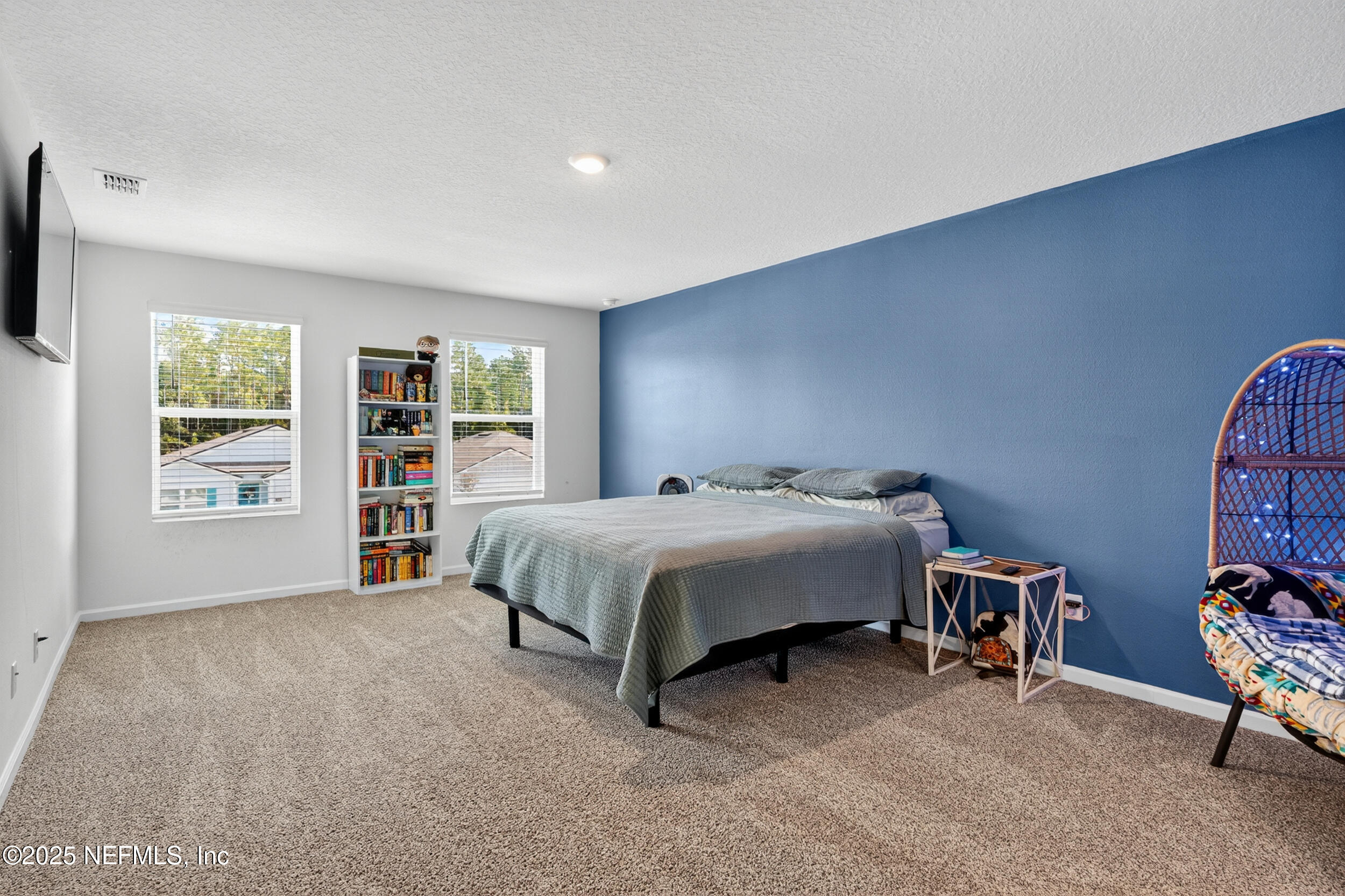 125 Hulett Wds Road Palm Coast, FL 32137 - Photo 23 of 40 a spacious bedroom with a bed and a window