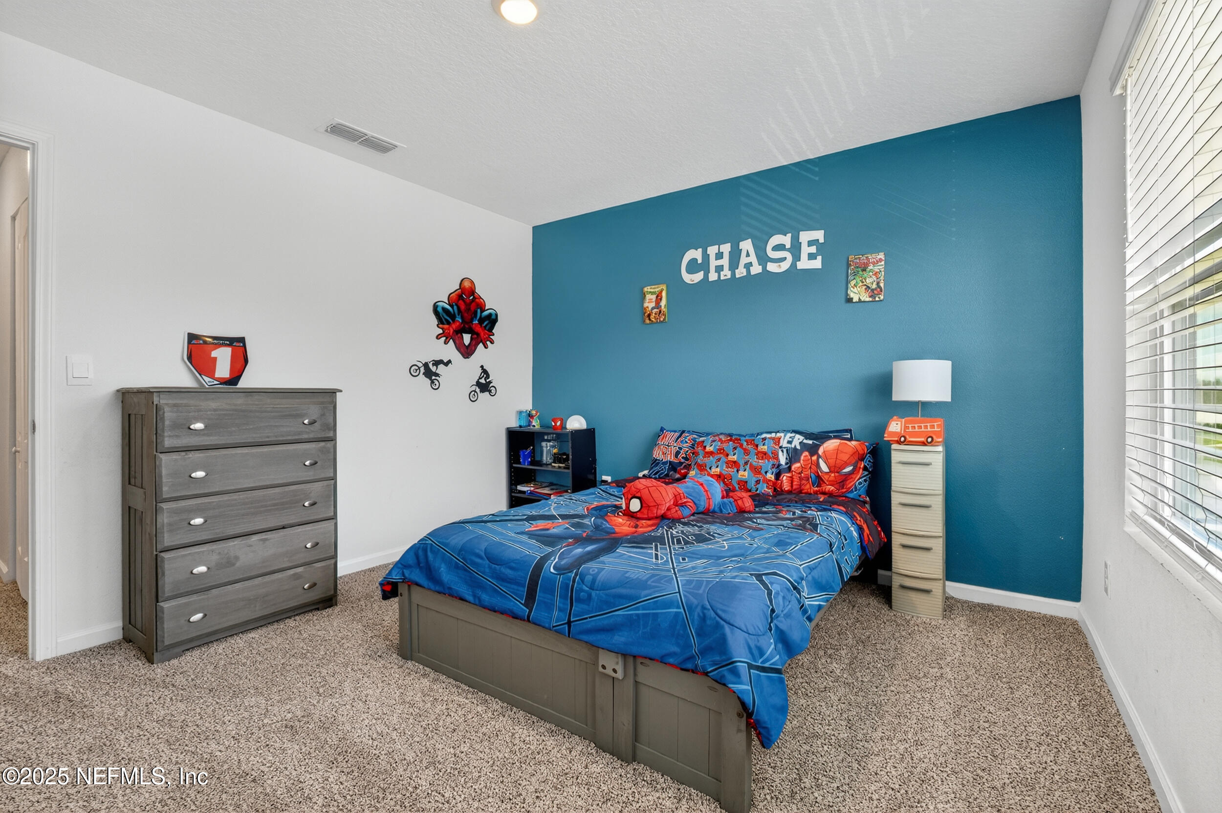 125 Hulett Wds Road Palm Coast, FL 32137 - Photo 28 of 40 a bedroom with a bed and a window