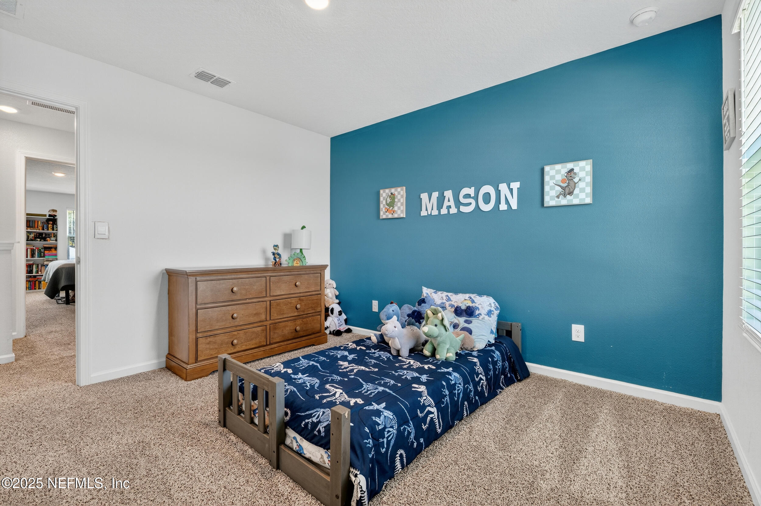 125 Hulett Wds Road Palm Coast, FL 32137 - Photo 31 of 40 a bedroom with a bed and a window