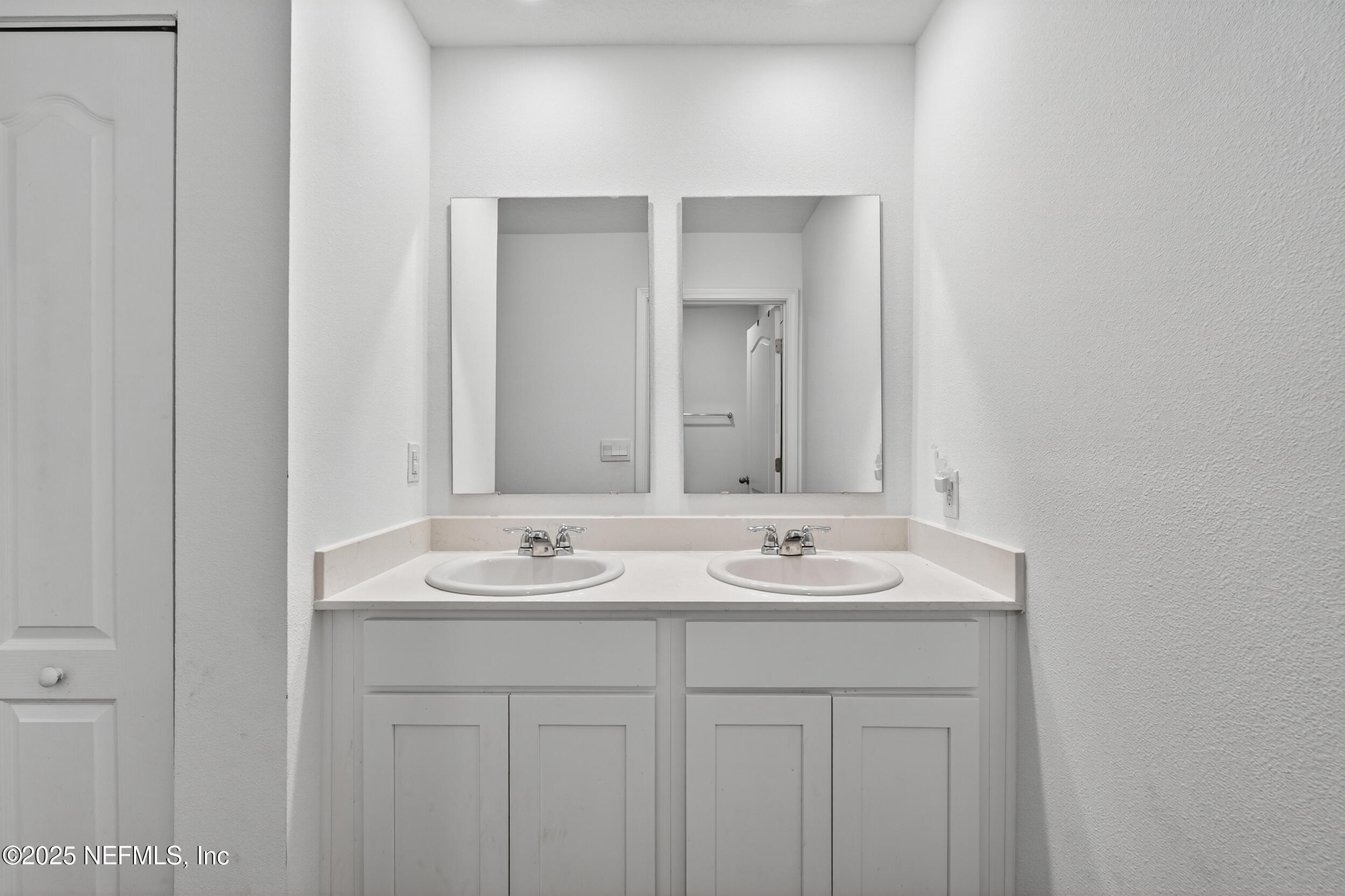 125 Hulett Wds Road Palm Coast, FL 32137 - Photo 32 of 40 a bathroom with a sink and a mirror