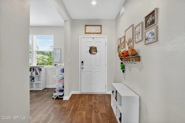 a view of an entryway with wooden floor