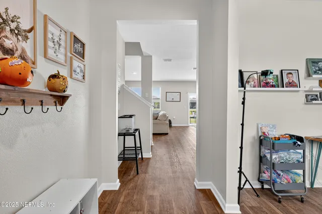 a view of living room filled with furniture and wooden floor