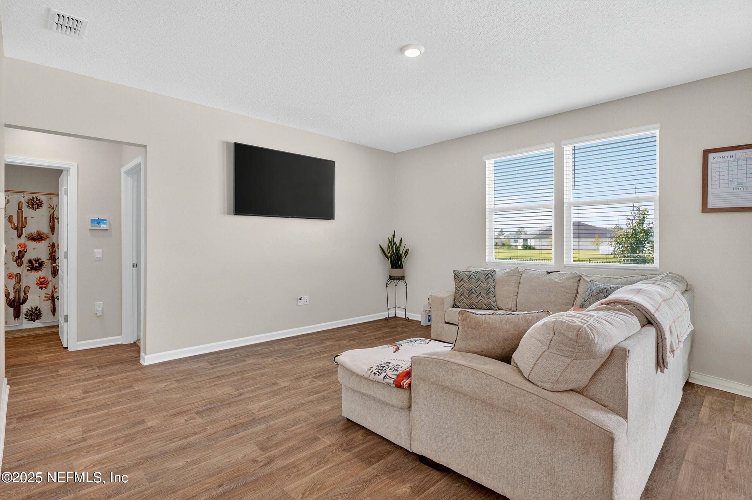 125 Hulett Wds Road Palm Coast, FL 32137 - Photo 8 of 40 a living room with furniture and a flat screen tv