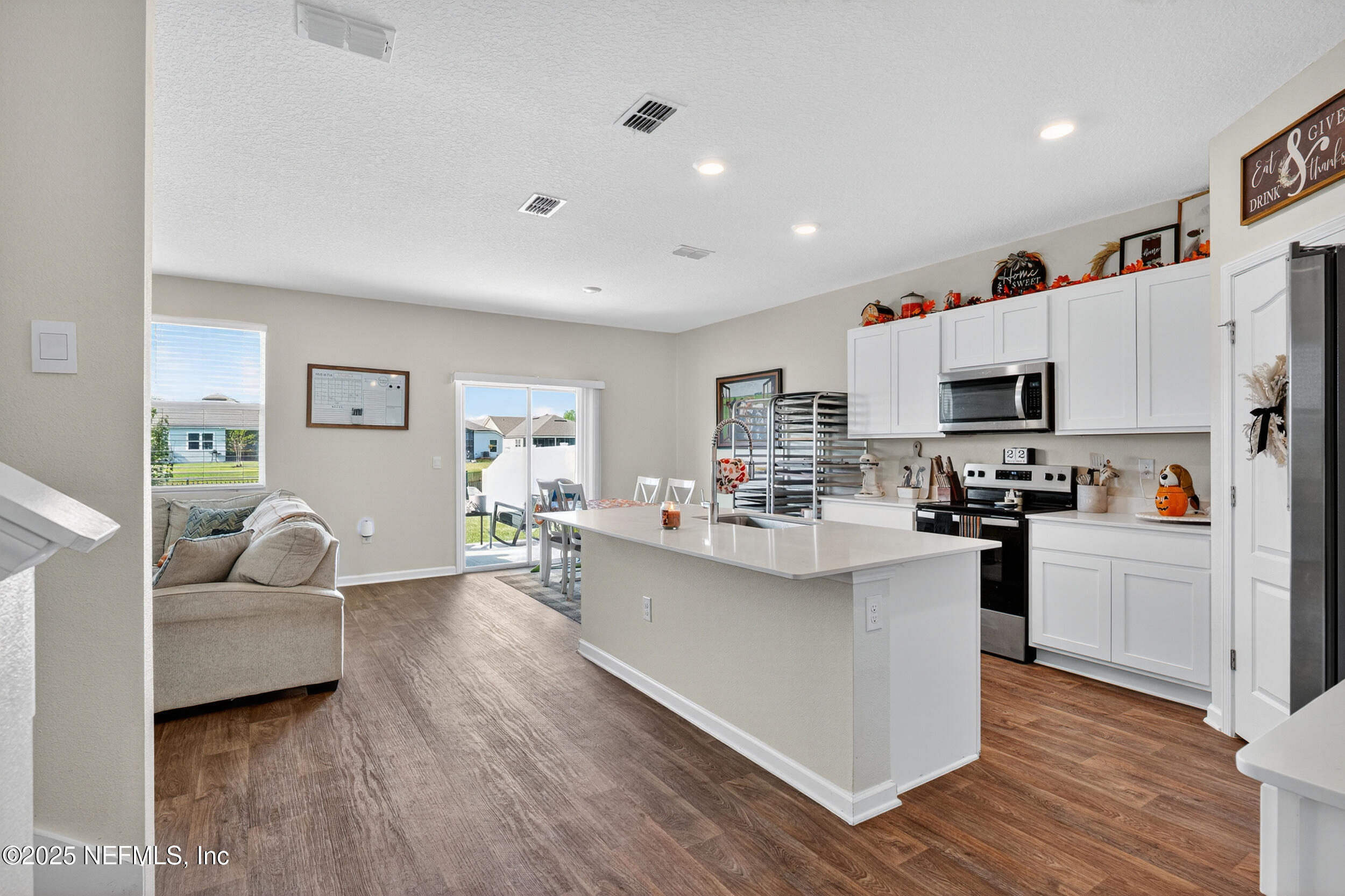 125 Hulett Wds Road Palm Coast, FL 32137 - Photo 10 of 40 a view of living room kitchen with furniture and wooden floor