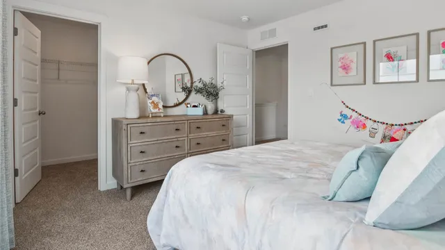 a bedroom with a bed and a dresser