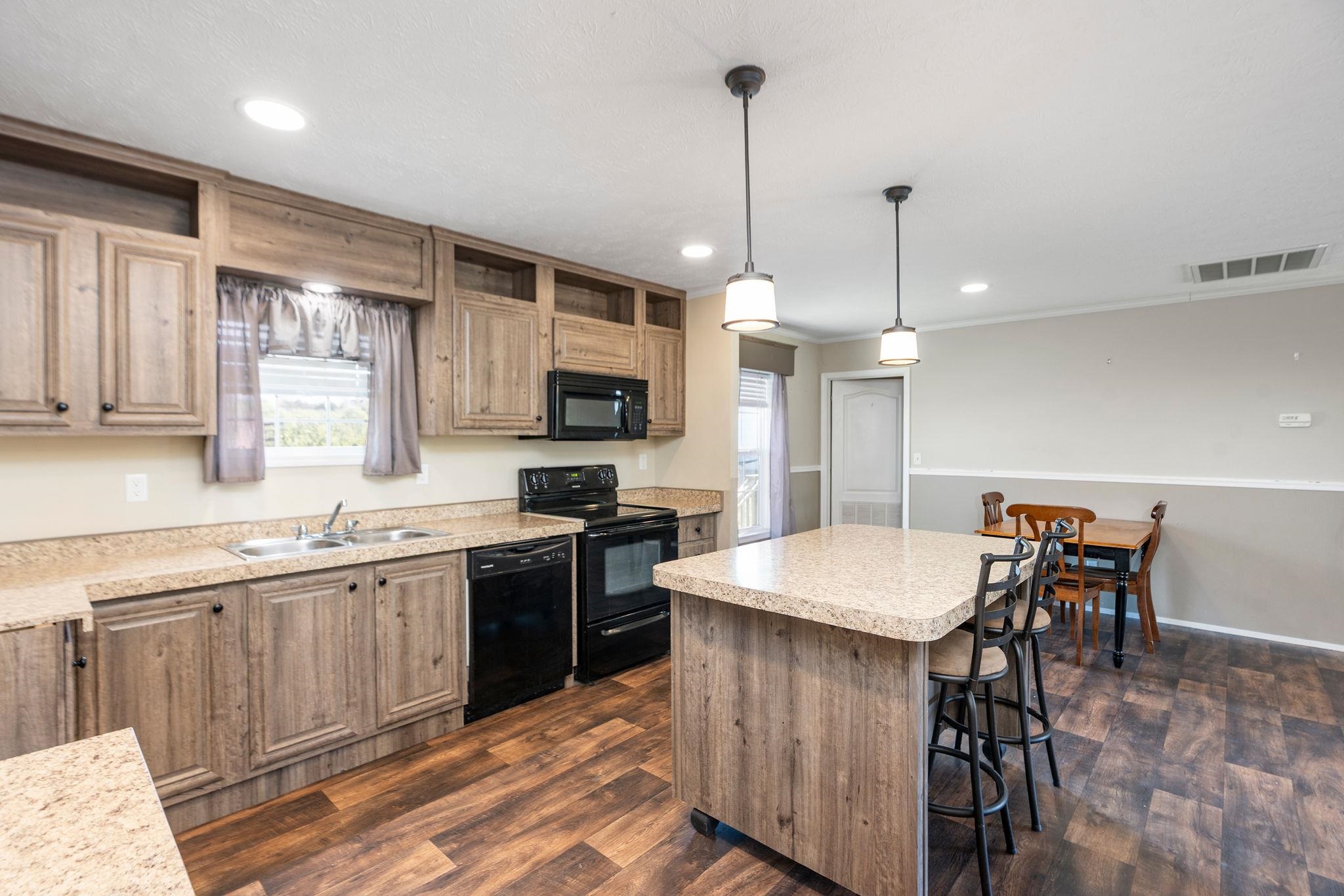 2061 Cecil Wampler Road Mount Crawford, VA 22841 - Photo 32 of 70 a kitchen with stainless steel appliances granite countertop a sink a stove a dining table and chairs