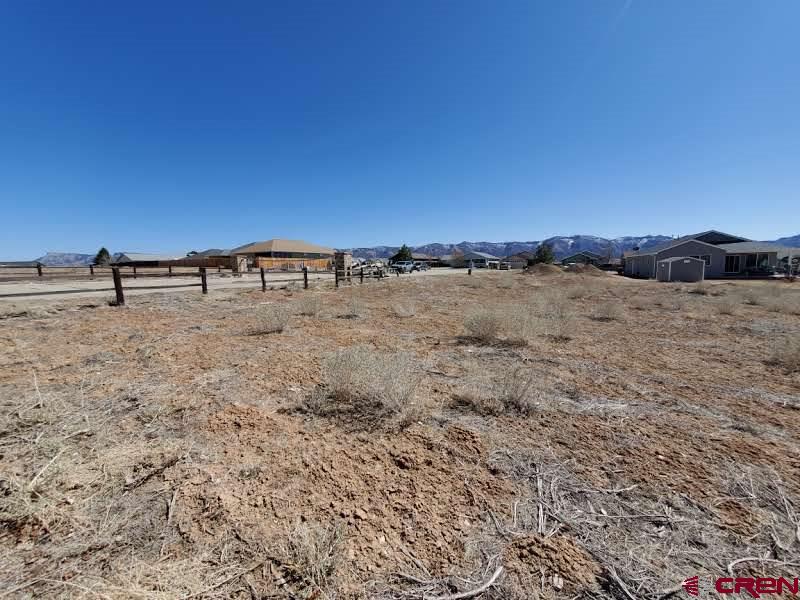 555 East 7th Street Cortez, CO 81321 - Photo 3 of 7 a view of a dry field with trees in the background