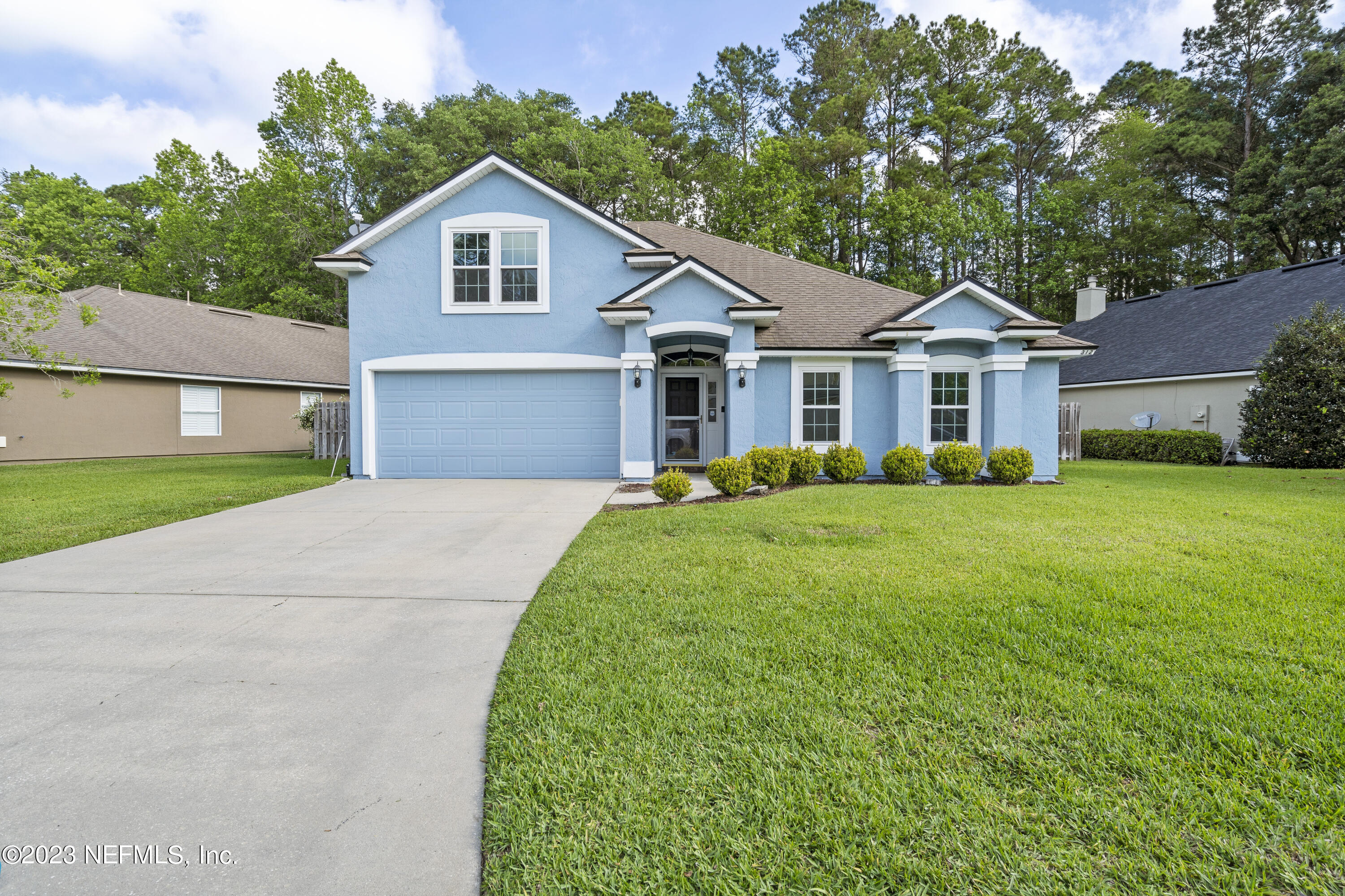 312 West Tropical Trace St. Johns, FL 32259 - Photo 1 of 57 front view of a house and a yard