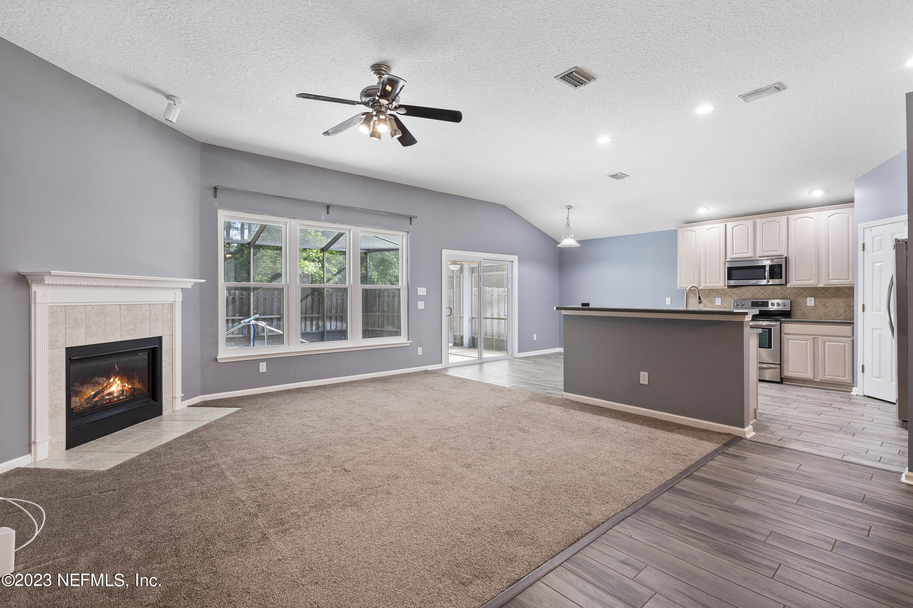 312 West Tropical Trace St. Johns, FL 32259 - Photo 16 of 57 a view of an empty room with a fireplace and a window