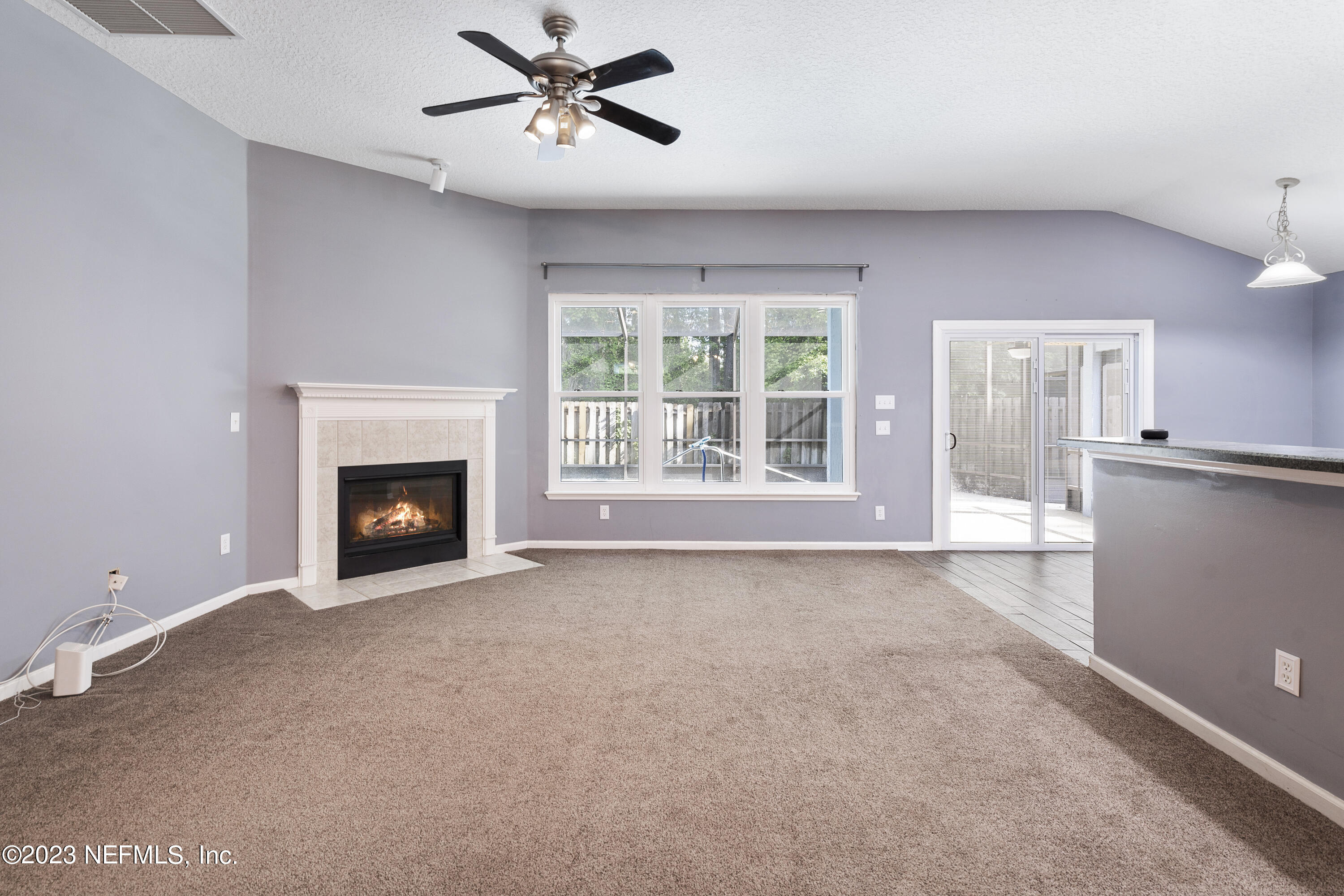 312 West Tropical Trace St. Johns, FL 32259 - Photo 17 of 57 a view of an empty room with a fireplace and a window